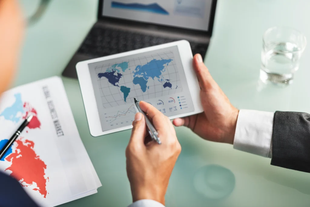 Business professionals reviewing global market data for a free zone trade license Dubai business setup and foreign investment planning