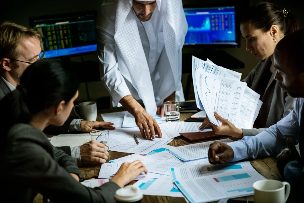 Business setup cost in Dubai consultation with professionals reviewing company formation documents and financial plans